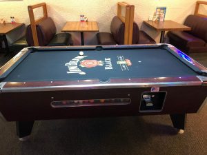 Jim Beam themed coin operated pool table with the cue ball on table